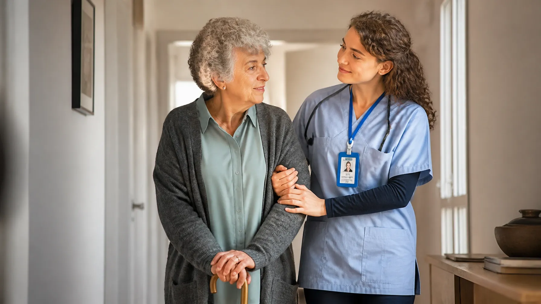 A caregiver providing steady walking support to an older adult at home as part of senior home care in New Jersey.