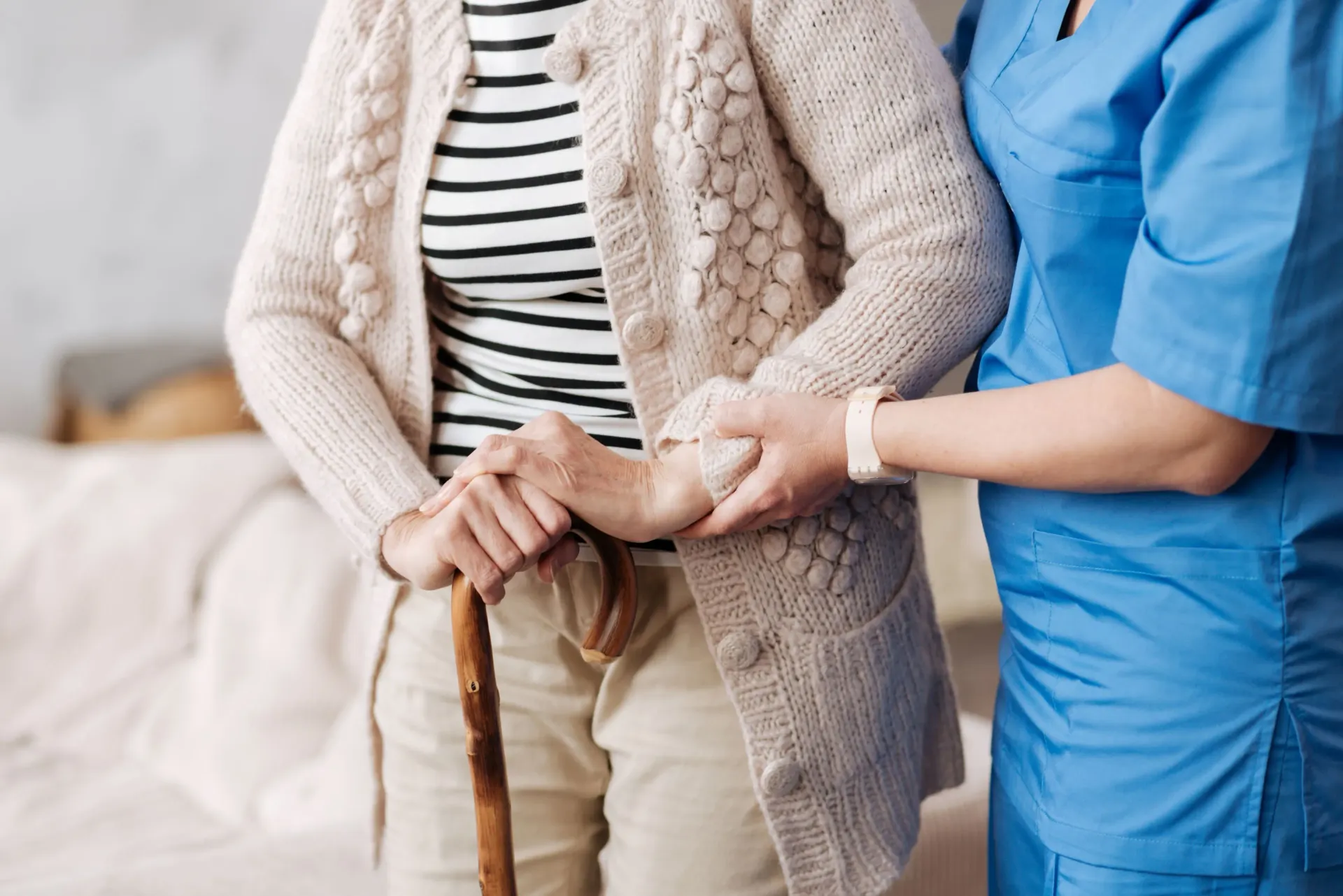 A home caregiver helping an older adult move safely and confidently through a daily routine